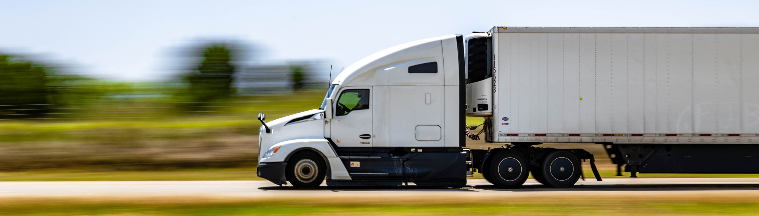 a semi truck moving along a rural road with some t 2025 02 10 06 17 53 utc 1